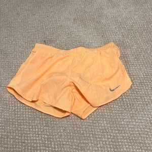 Orange Nike running shorts